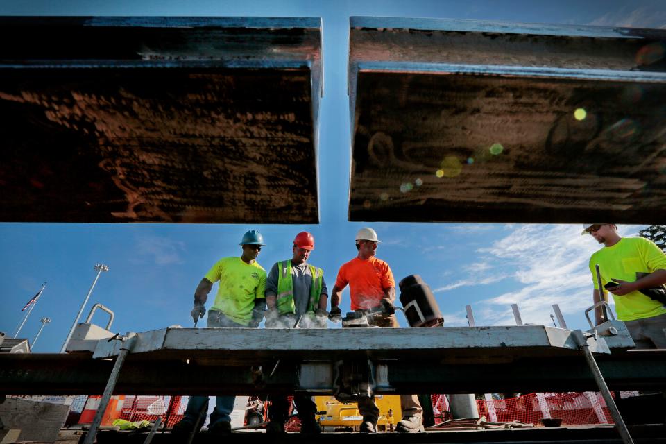 Mass Coastal Railroad workers thermite weld two pieces of track together for the extension they are installing adjacent to Route 18 in downtown New Bedford. As a result of continuously welded rail, the South Coast Rail trains will not only be faster than freight trains but quieter as well, making safety an even greater concern.