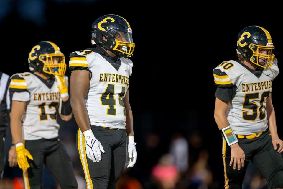 Enterprise junior defensive Justus Williams (center) prepares to read the offense at the line of scrimmage with senior Jarrett Butcher (right) on Friday, Aug. 25, 2023.
