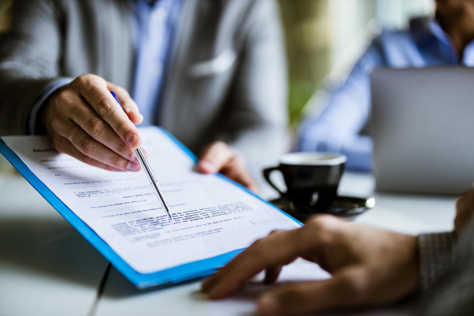 Person points to where a document needs to be signed