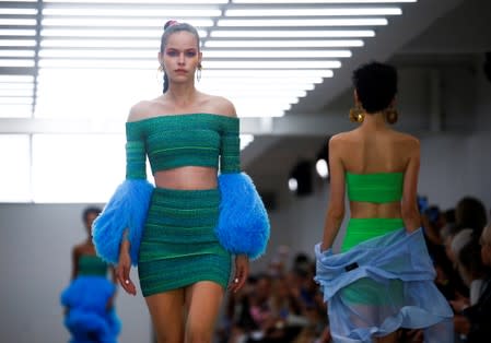 Models present creations during the Mark Fast catwalk show at London Fashion Week in London