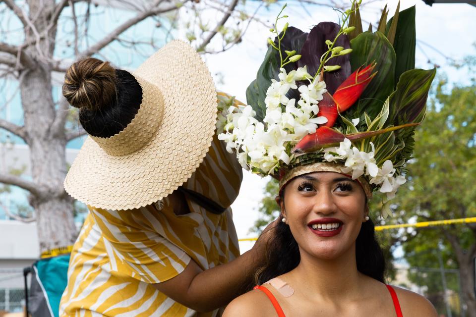 Juaul Aukusitino helps Hinei Aukusitino, 19, get ready for the Tahitian Competition at Polynesian Days Utah at Electric Park at Thanksgiving Point in Lehi on Saturday, Sept. 2, 2023. | Megan Nielsen, Deseret News