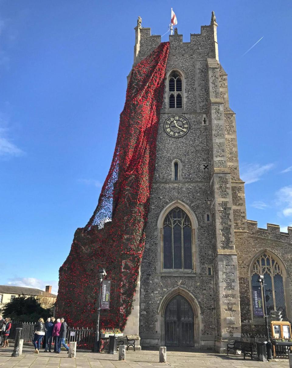 A cascade of knitted and crocheted poppies hanging from St Peter’s Church in Sudbury to mark 100 years since the end of the First World War (Sam Russell/PA)