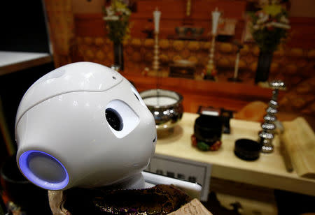 A 'robot priest' wearing a Buddhist robe stands in front of a funeral altar during its demonstration at Life Ending Industry EXPO 2017 in Tokyo, Japan August 23, 2017. REUTERS/Kim Kyung-Hoon