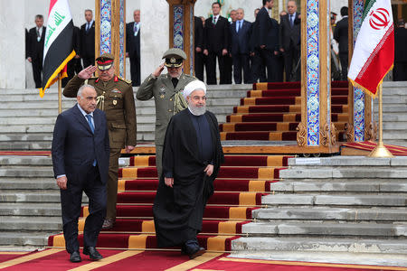 Iranian President Hassan Rouhani walks with Iraq's Prime Minister Adel Abdul Mahdi during a welcome ceremony in Tehran, Iran, April 6, 2019. Official Iranian President website/Handout via REUTERS