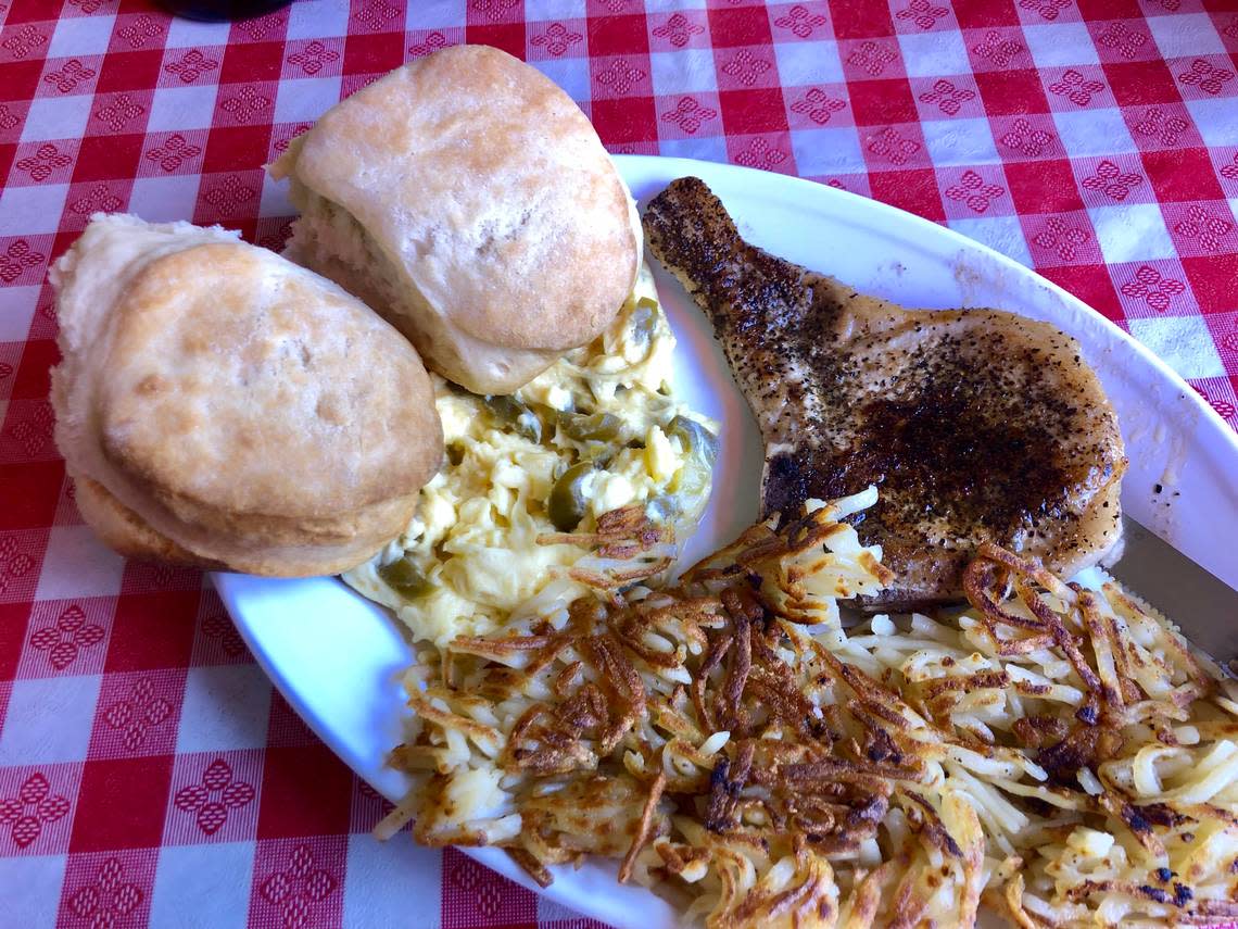 Scrambled eggs with jalapenos, a pork chop, biscuits and hash browns at Montgomery Street Cafe.