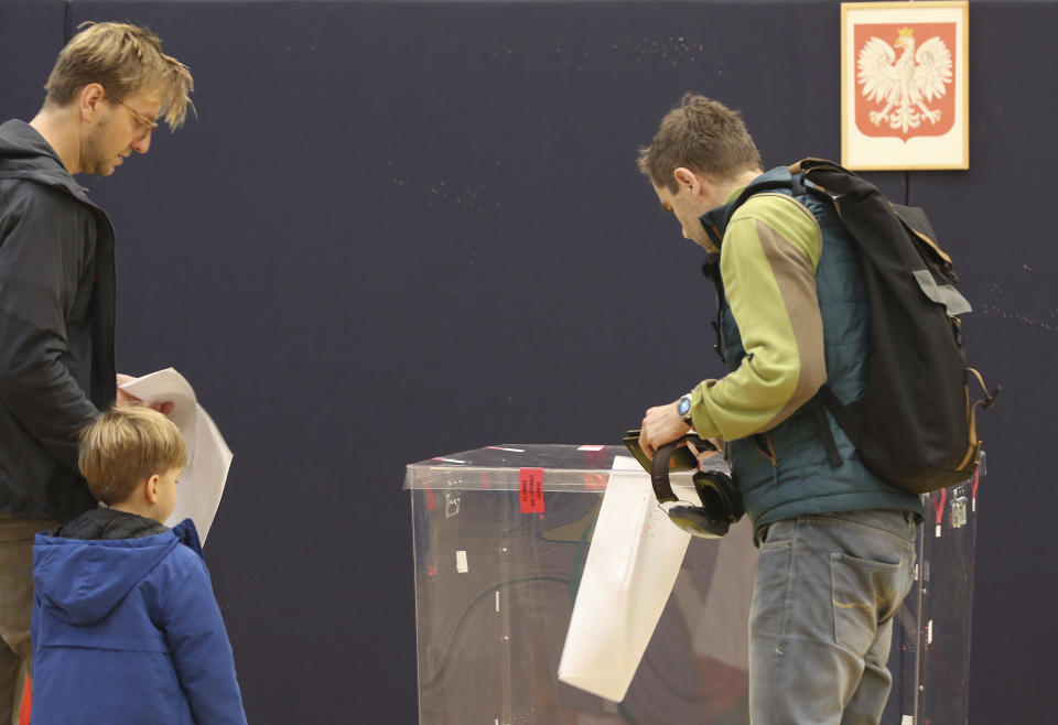 People vote by ballot in an election to the Polish parliament in Warsaw, Poland, on Oct. 13, 2019. Poles are voting Sunday in a parliamentary election, that the ruling party of Jaroslaw Kaczynski is favored to win easily, buoyed by the popularity of its social conservatism and generous social spending policies that have reduced poverty. (AP Photo/Czarek Sokolowski)