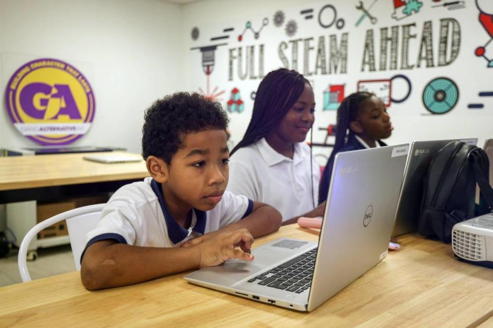 Corey King, 8, third grader, and a pair of fourth graders - Aaliyah Washington, 10, center, and Jada Ivory, 10, right - create three-dimensional shapes with the help of computers as part of the Fab Lab launched at the Phichol Williams Community Center in Homestead, Florida on Wednesday, Jan. 17, 2024.