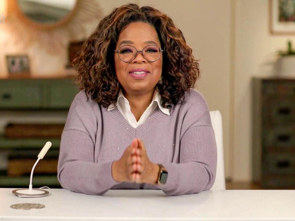 Oprah Winfrey sitting at desk