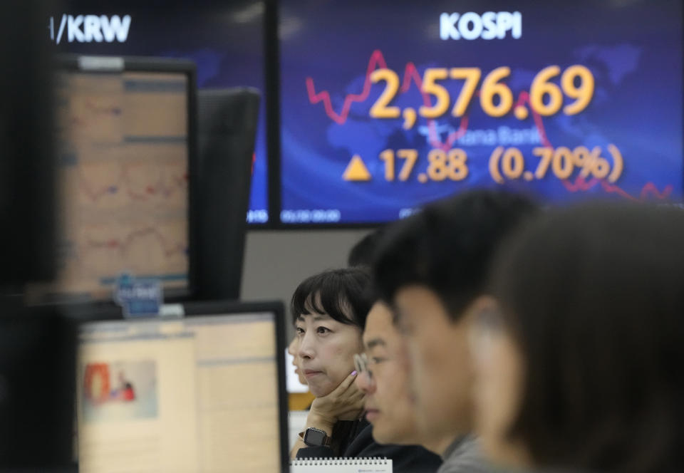 Currency traders watch monitors near the screen showing the Korea Composite Stock Price Index (KOSPI) at the foreign exchange dealing room of the KEB Hana Bank headquarters in Seoul, South Korea, Tuesday, May 30, 2023. Asian shares were mixed in directionless trading Tuesday following a U.S. holiday, as optimism about a deal on the U.S. debt mixed with worries about the regional economy. (AP Photo/Ahn Young-joon)