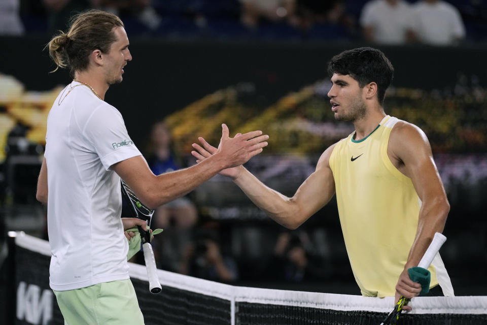 Alexander Zverev, left, of Germany is congratulated by Carlos Alcaraz of Spain following their quarterfinal match at the Australian Open tennis championships at Melbourne Park, Melbourne, Australia, early Thursday, Jan. 25, 2024. (AP Photo/Alessandra Tarantino)