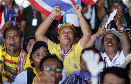 Anti-government protesters blow their whistles during a rally outside the office of Election Commission in Bangkok May 15, 2014. REUTERS/Chaiwat Subprasom