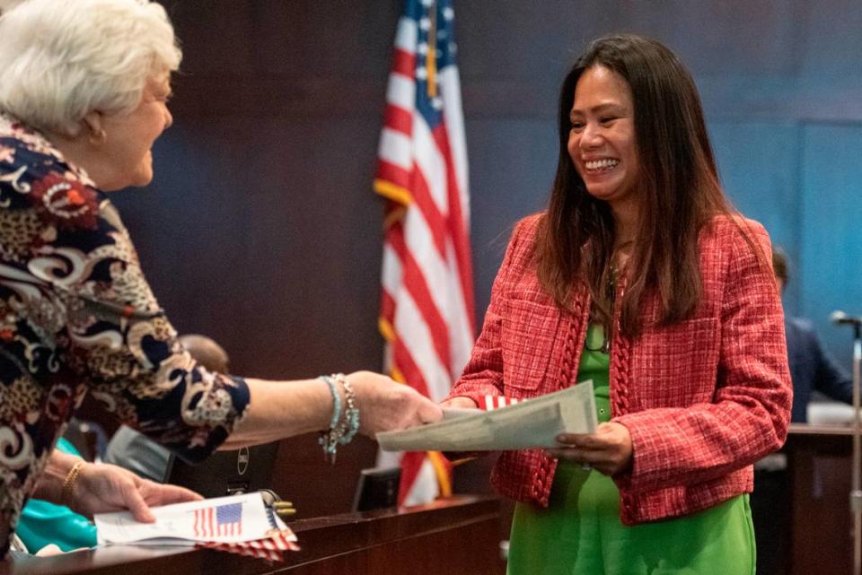 Lani Edwards, an immigrant from the Philippines, smiles as she receives her naturalization documents and an American flag during a naturalization ceremony at Dan M. Russell Courthouse in Gulfport on Thursday, Oct. 19, 2023.