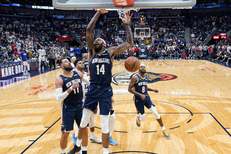 New Orleans Pelicans forward Brandon Ingram (14) slam dunks in the first half of an NBA basketball game against the Philadelphia 76ers in New Orleans, Wednesday, Oct. 20, 2021. (AP Photo/Gerald Herbert)