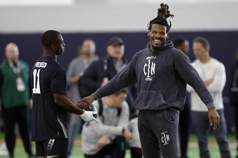 Former NFL and Auburn quarterback, Cam Newton, talks with receiver Sheddrick Jackson (11) during Auburn Pro Day, Tuesday, March 21, 2023, in Auburn, Ala. (AP Photo/Butch Dill)