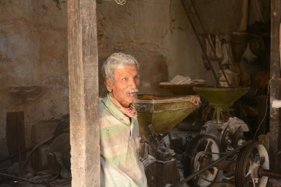 Manakaji Darbar, pictured at the wheat flour mill in Vadnagar, is a star in his neighbourhood due to his childhood association with the prime minister (Namita Singh/The Independent)