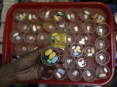 A nurse prepares doses of drugs for HIV and AIDS patients at Buddhist temple Wat Prabat Namphu in Lopburi province, north of Bangkok September 4, 2014. REUTERS/Chaiwat Subprasom