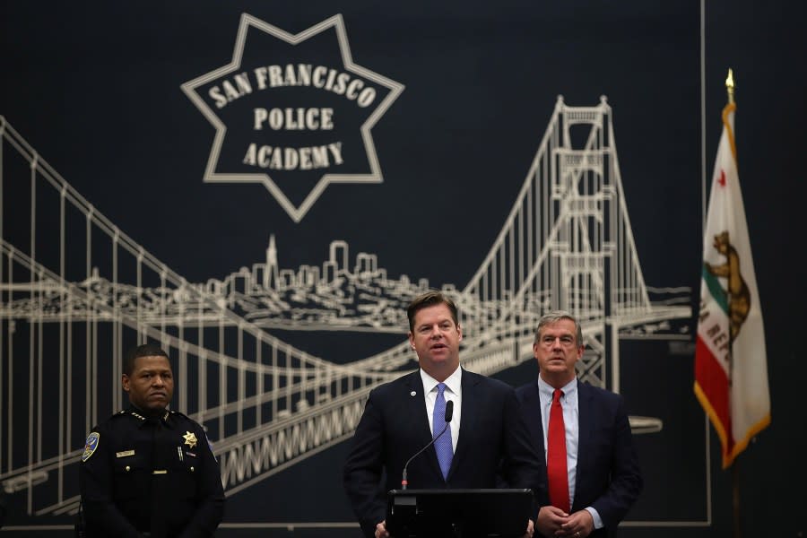 Then-San Francisco mayor Mark Farrell (C) and police chief Bill Scott (L) look on during a news conference at the San Francisco Police Academy on May 15, 2018. (Photo by Justin Sullivan /Getty Images)