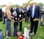 <p>U.S. President Donald Trump high fives young Christian Jacobs, son of US Marine Christopher Jacobs, who was killed in a training exercise at Twentynine Palms, California, as his mother Brittany watches, at Section 60 of Arlington National Cemetery as part of Memorial Day observance, Arlington, Virginia, U.S., May 29, 2017. (Photo: Mike Theiler/Reuters) </p>