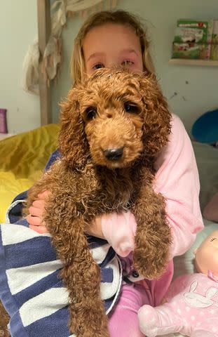 <p>Lindsay Czarniak/Instagram</p> Sybil cuddled the pup after his bath.