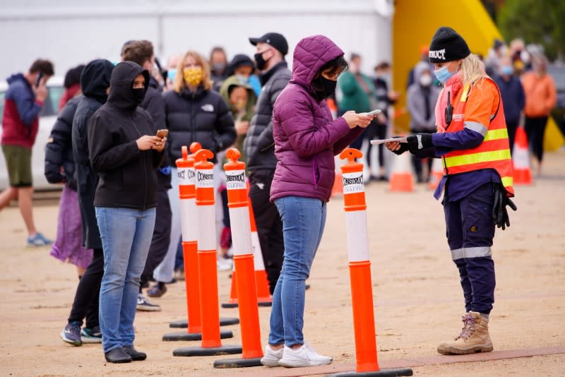 A woman checks in for a COVID-19 test at a locked down residential complex in Melbourne