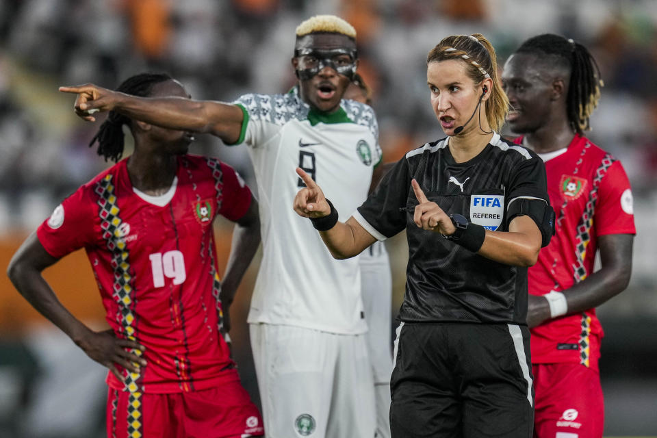 Referee Bouchra Karboubi signs for the VAR during the African Cup of Nations Group A soccer match between Guinea Bissau and Nigeria, at the Felix Houphouet Boigny stadium in Abidjan, Ivory Coast, Monday, Jan. 22, 2024. (AP Photo/Themba Hadebe)