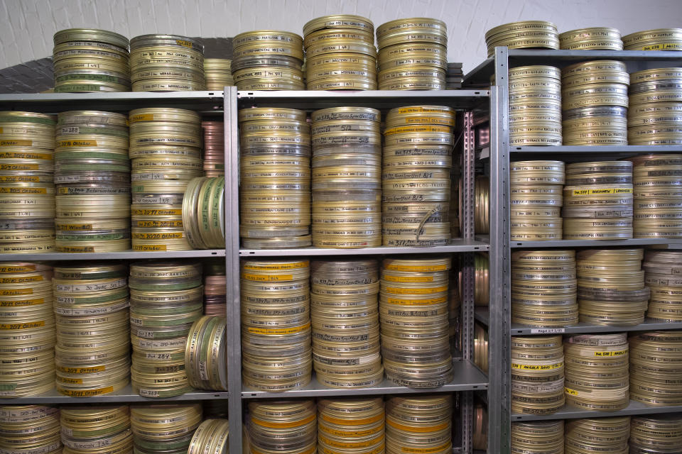 In this Wednesday, June 17, 2020 photo reels of film are stacked in the archive of PROGRESS Film, in Leipzig, Germany. A new project is underway to digitize thousands of East German newsreels, documentaries and feature films 30 years after Germany’s reunification. The movies that are being scanned, transcribed and posted online provide a look inside a country that no longer exists but was a critical part of the Cold War. (AP Photo/Jens Meyer)