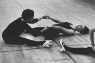 Caption from LIFE. "Mary Ann de Mare, 19, winces in pain as she stretches during strenuous warm-up exercises with Sue Borin, 21, prior to rehearsal." (Art Rickerby—Time & Life Pictures/Getty Images) <br> <br> <a href="http://life.time.com/culture/hard-knocks-high-kicks-life-with-the-rockettes-1964/#1" rel="nofollow noopener" target="_blank" data-ylk="slk:Click here to see the full collection at LIFE.com;elm:context_link;itc:0;sec:content-canvas" class="link ">Click here to see the full collection at LIFE.com</a>