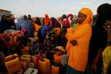 Displaced women from drought hit areas wait to fill their jerrycans as they gather at the water point at a camp for internally displaced people in Dollow, Somalia April 3, 2017. REUTERS/Zohra Bensemra