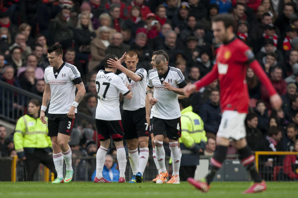 Fulham's Steve Sidwell, centre, celebrates with teammates after scoring against Manchester United during their English Premier League soccer match at Old Trafford Stadium, Manchester, England, Sunday Feb. 9, 2014. (AP Photo/Jon Super)