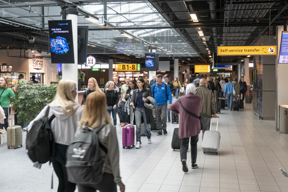 Passengers are seen walking with their luggage or waiting for boarding on the aircraft inside the terminal, the arrival and departure hall, the gates and baggage belt area of Amsterdam Schiphol Airport AMS EHAM before their departure or after their arrival. During the summer of 2022 the European Aviation industry is facing long delays, cancellations and travel chaos mostly because of staff shortages at the airports after the Covid-19 Coronavirus pandemic era lifting travel measures and restrictions or usage of facemask, air travel had increased demand for business travel, leisure and holidays and one of the most affected airports is Amsterdam Schiphol Airport. Amsterdam, the Netherlands on October 2022 (Photo by Nicolas Economou/NurPhoto via Getty Images)