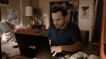 A man typing on a laptop