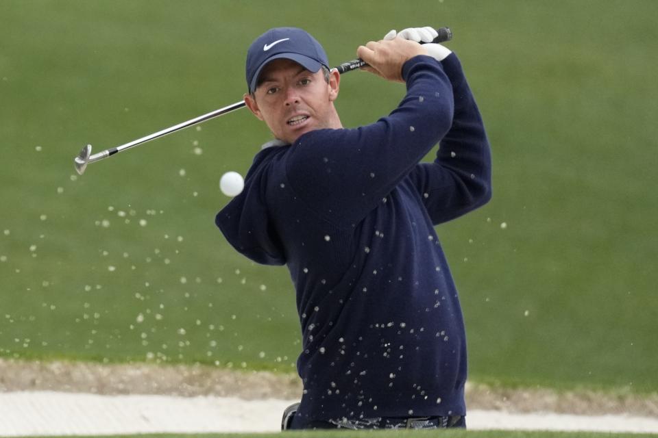 Rory McIlroy, of Northern Ireland, hits out of a bunker on the 16th hole during a practice for the Masters golf tournament at Augusta National Golf Club, Monday, April 3, 2023, in Augusta, Ga. (AP Photo/Mark Baker)