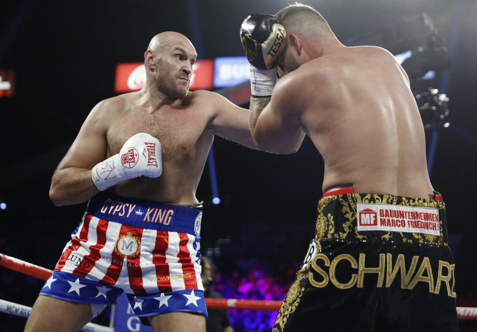 Tyson Fury, left, of England, tries to hit Tom Schwarz, of Germany, with a left during a heavyweight boxing match Saturday, June 15, 2019, in Las Vegas. (AP Photo/John Locher)