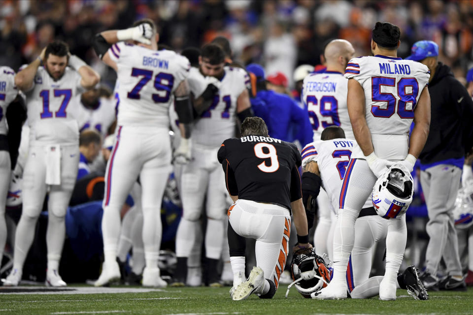 Cincinnati Bengals quarterback Joe Burrow (9) pauses as Buffalo Bills' Damar Hamlin is examined by medical staff during the first half of an NFL football game, Monday, Jan. 2, 2023, in Cincinnati. (AP Photo/Emilee Chinn)