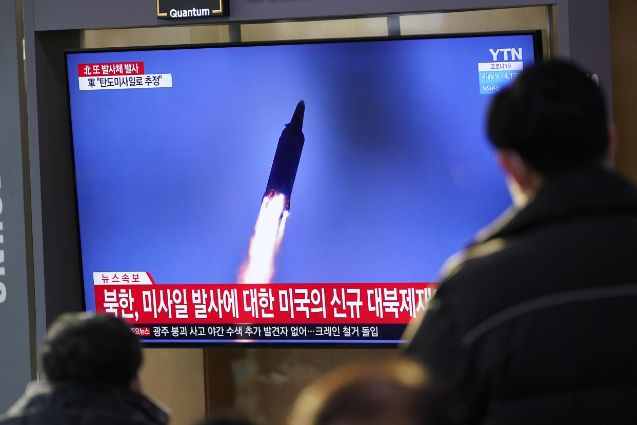 People watch a TV screen showing a news program reporting about North Korea's missile launch with a file image, at a train station in Seoul, South Korea, Friday, Jan. 14, 2022. North Korea on Friday fired two short-range ballistic missiles in its third weapons launch this month, officials in South Korea said, in an apparent reprisal for fresh sanctions imposed by the Biden administration for its continuing test launches. (AP Photo/Lee Jin-man)