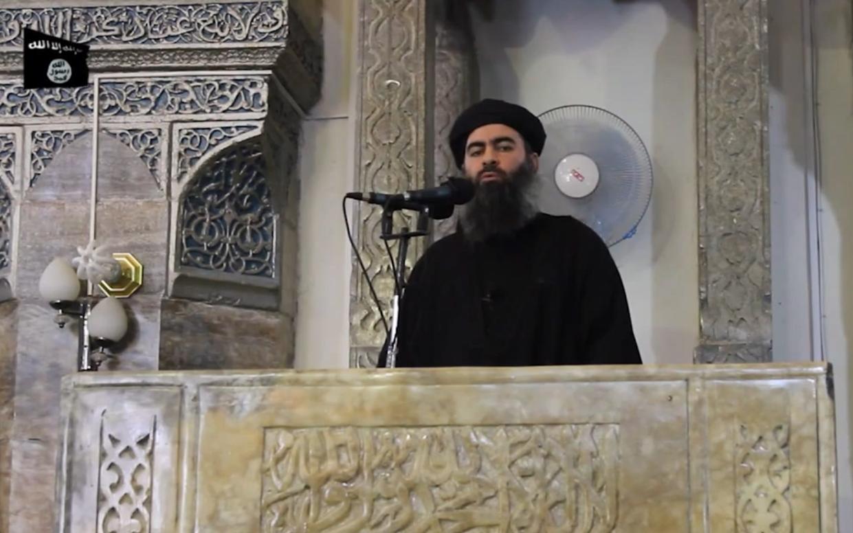 Abu Bakr al-Baghdadi addressing worshippers at a mosque in Mosul in 2014 - AFP