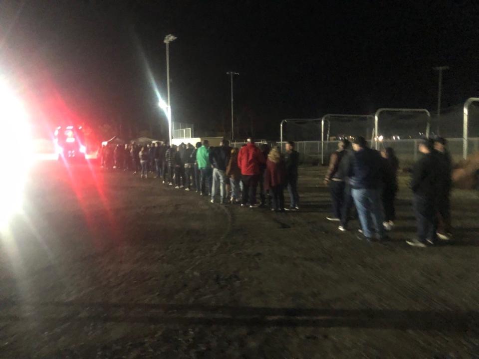 More than 100 people waited in line for a shuttle Wednesday, Dec. 14, 2022 that would take them from overflow parking at Xavier College Preparatory High School to Acrisure Arena for the Chris Rock and Dave Chappelle opening night show.