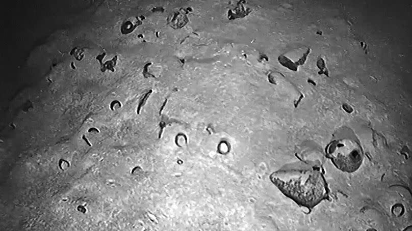 Underwater image shows the shipwreck, showing the sunken boat buried beneath a layer of ancient jugs.