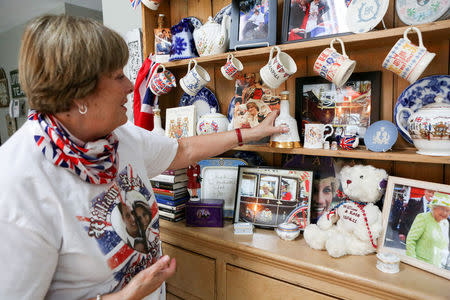 FILE PHOTO: Royal superfan Donna Werner looks over some of the photos and memorabilia she has collected traveling to England for the weddings of Prince Andrew, Prince William and Queen Elizabeth's 90th birthday celebration, at her home in New Fairfield, Connecticut, U.S. March 20, 2018. REUTERS/Michelle McLoughlin