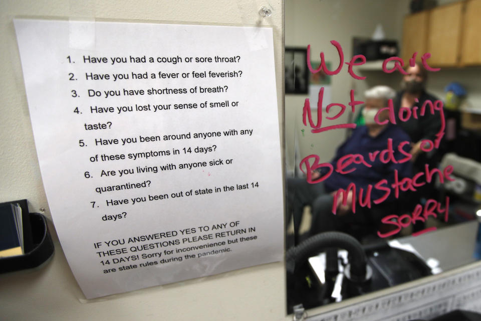 A list of requirements to allow a person to get a haircut are posted at Kilroy's Haircutters, Friday, May 1, 2020, in Brunswick, Maine. Gov. Janet Mills has allowed barber shops and some other businesses to reopen Friday under strict guidelines to help prevent the spread of the coronavirus. (AP Photo/Robert F. Bukaty)