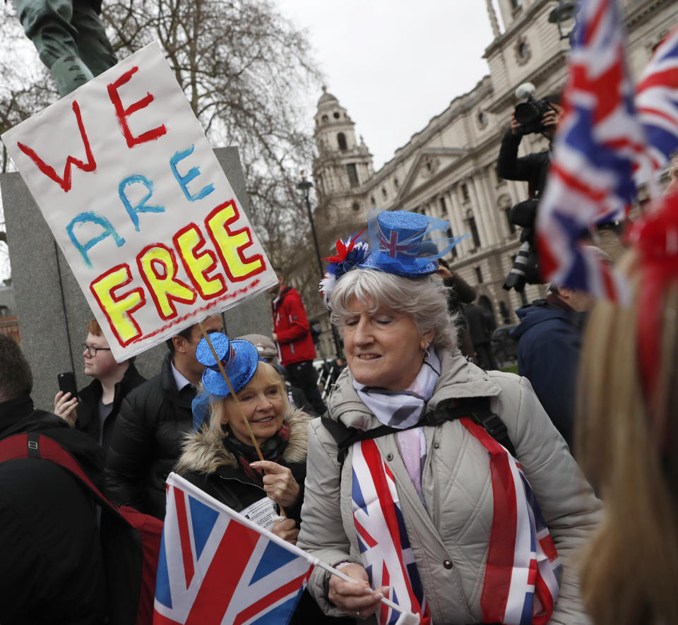 FILE - In this Friday, Jan. 31, 2020 file photo Brexiteers celebrate in London. Britain officially leaves the European Union on Friday after a debilitating political period that has bitterly divided the nation since the 2016 Brexit referendum. (AP Photo/Alastair Grant, File)