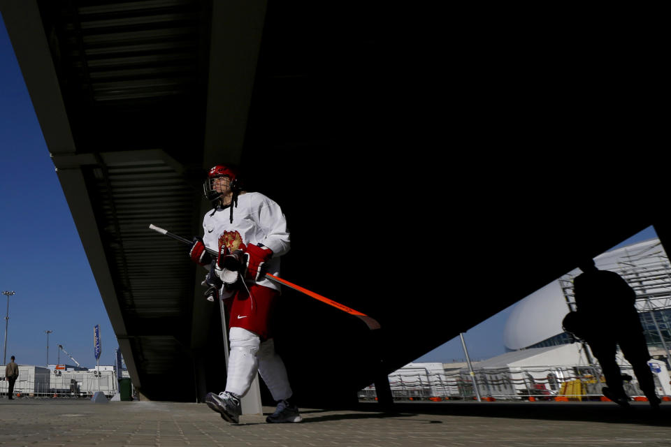 Team Russia defender Alexandra Kapustina walks under an overpass after working out during the 2014 Winter Olympics, Monday, Feb. 10, 2014, in Sochi, Russia. (AP Photo/Julio Cortez)