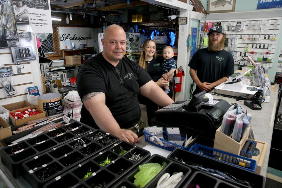 Gabriel Tackle Co. co-owners Frank Giacolone III (left) is shown with his son Frank Giacolone IV and daughter Rachael Giacolone holding her son Vincent, 9 months, at the Mantoloking Road shop in Brick Monday, June 13, 2022.  The five-year-old bait and tackle shop also has a location in Lavallette. 