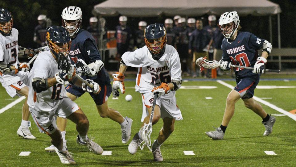 Caden Hayes chases down a loose ball moving toward the sideline during the second half of Friday night's matchup between Benjamin and Oxbridge on April 1, 2022.