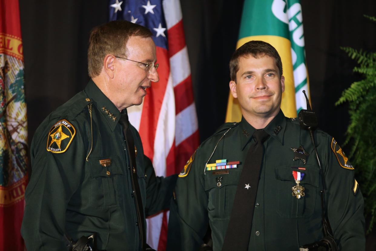 Polk County Sheriff Grady Judd presents Deputy Sean Speakman with the Medal of Honor during the 2013 Polk County Sheriff's Office Annual Awards Ceremony.