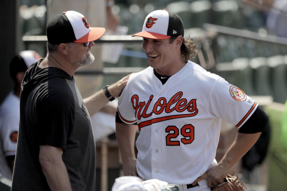 Baltimore Orioles starting pitcher Asher Wojciechowski, right, talks to pitching coach Doug Brocail in the dugout after being pulled from the mound during the eighth inning of a baseball game against the Baltimore Orioles, Sunday, July 21, 2019, in Baltimore. The Orioles won 5-0. (AP Photo/Julio Cortez)