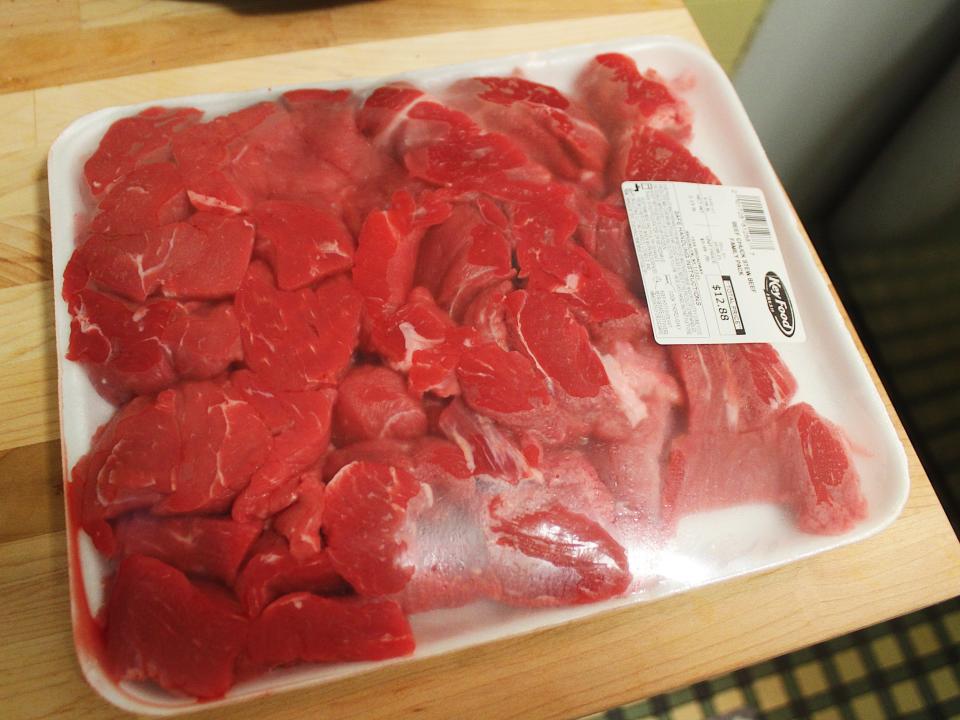 stew beef in plastic packaging on a wooden counter