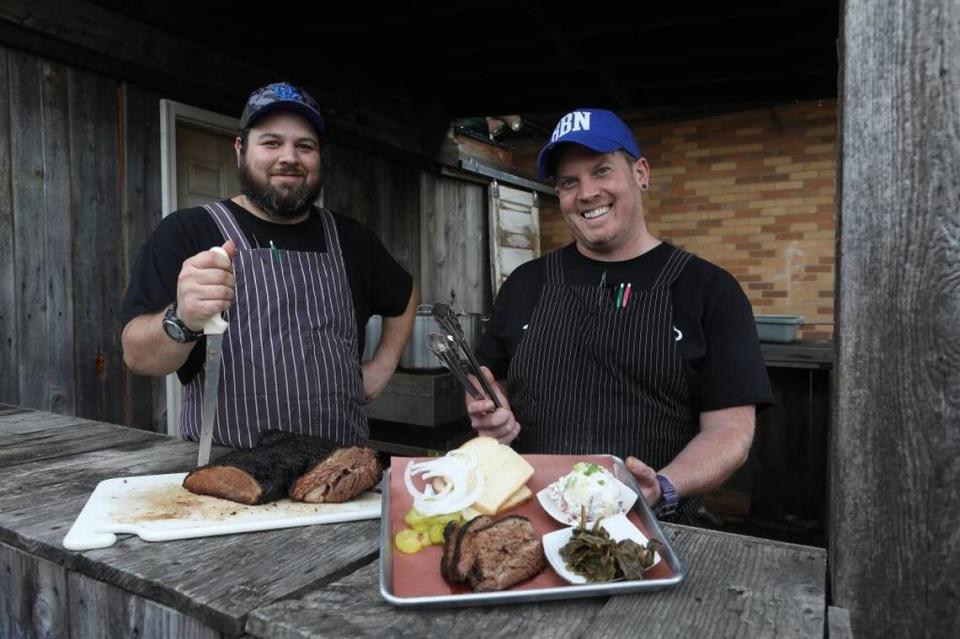 Blue Door Smokehouse co-owners Jeff Newman and Jon Rigsby, with brisket and platter in a 2017 photo. Blue Door is planning to move to a bigger location on National Avenue.