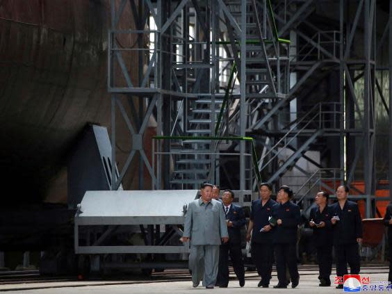 Kim Jong Un seen inspecting submarine at an unknown location in North Korea (AP)