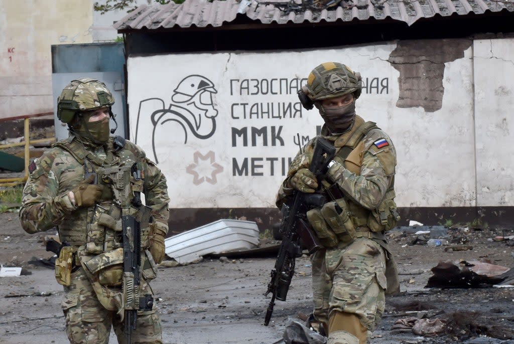 Russian soldiers guard part of the Ilyich Iron and Steel Works in Mariupol, Ukraine, on 18 May, 2022 (AFP via Getty Images)